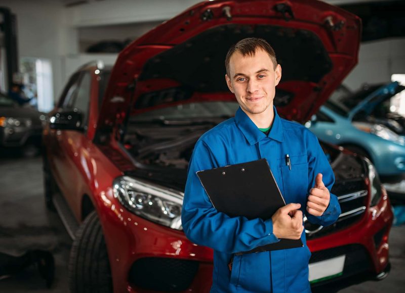 technician-with-notebook-car-with-opened-hood-small.jpg